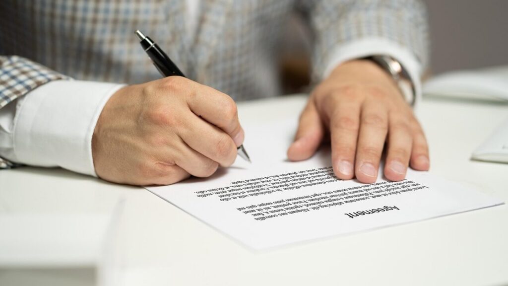 Man Signing Papers